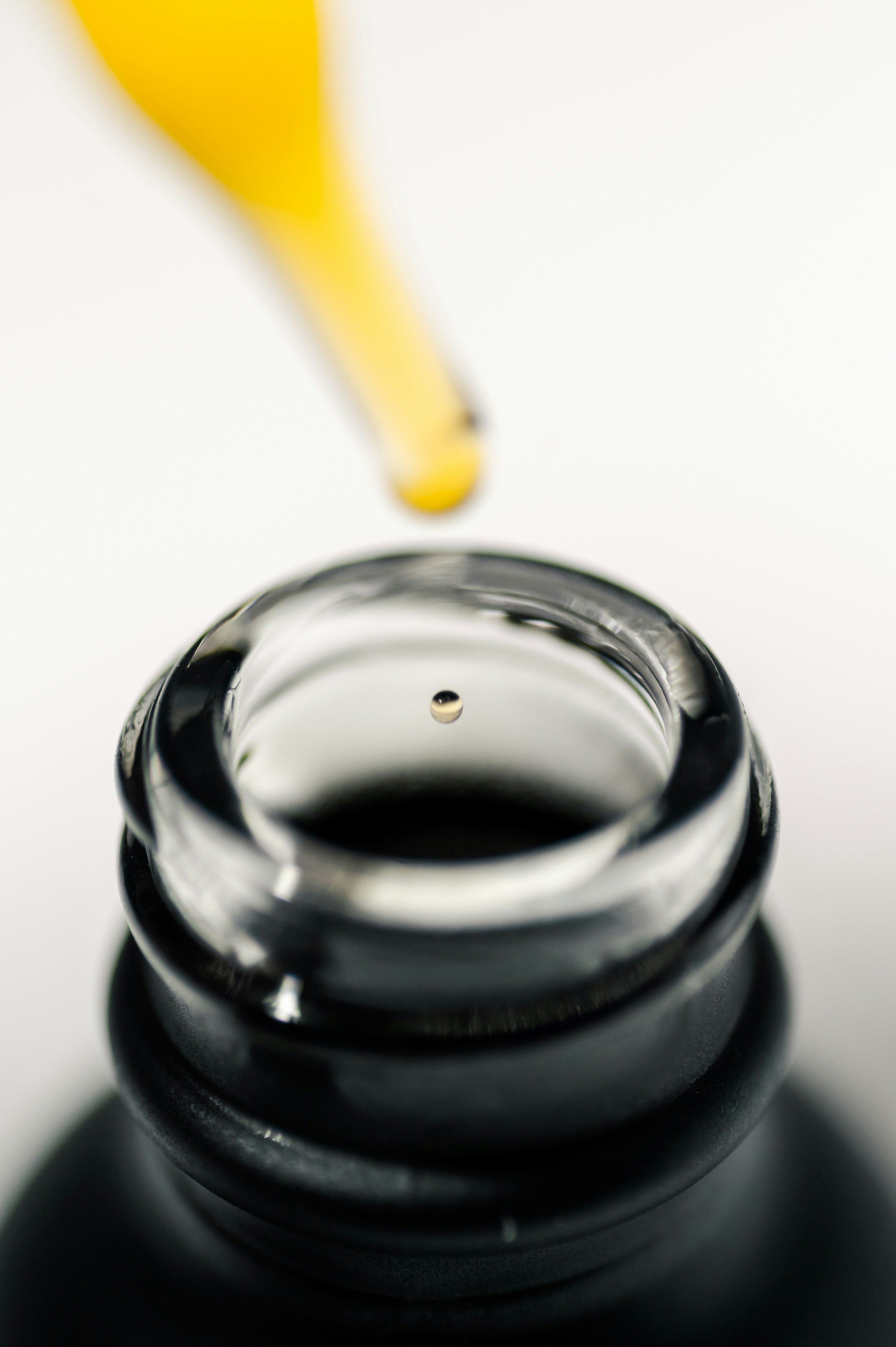 silver round container with yellow handle